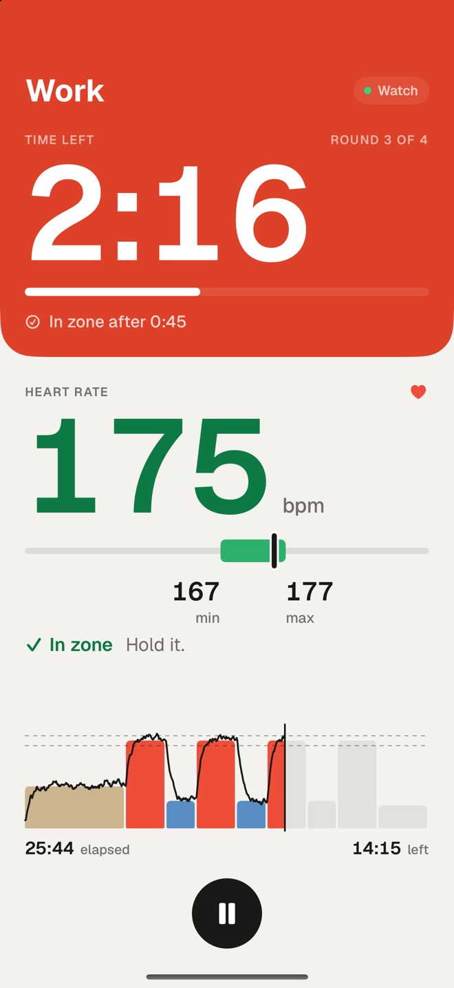 Fjell's running screen during a work round: time left on the red work block with the halfway status under it, and heart rate in the zone below, in green, with its gauge.